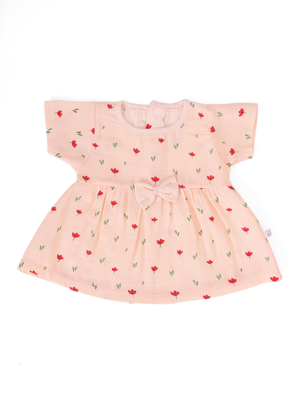 A short-sleeved peach-colored muslin frock with a bow at the front and a floral pattern. The frock has back buttons for closure.