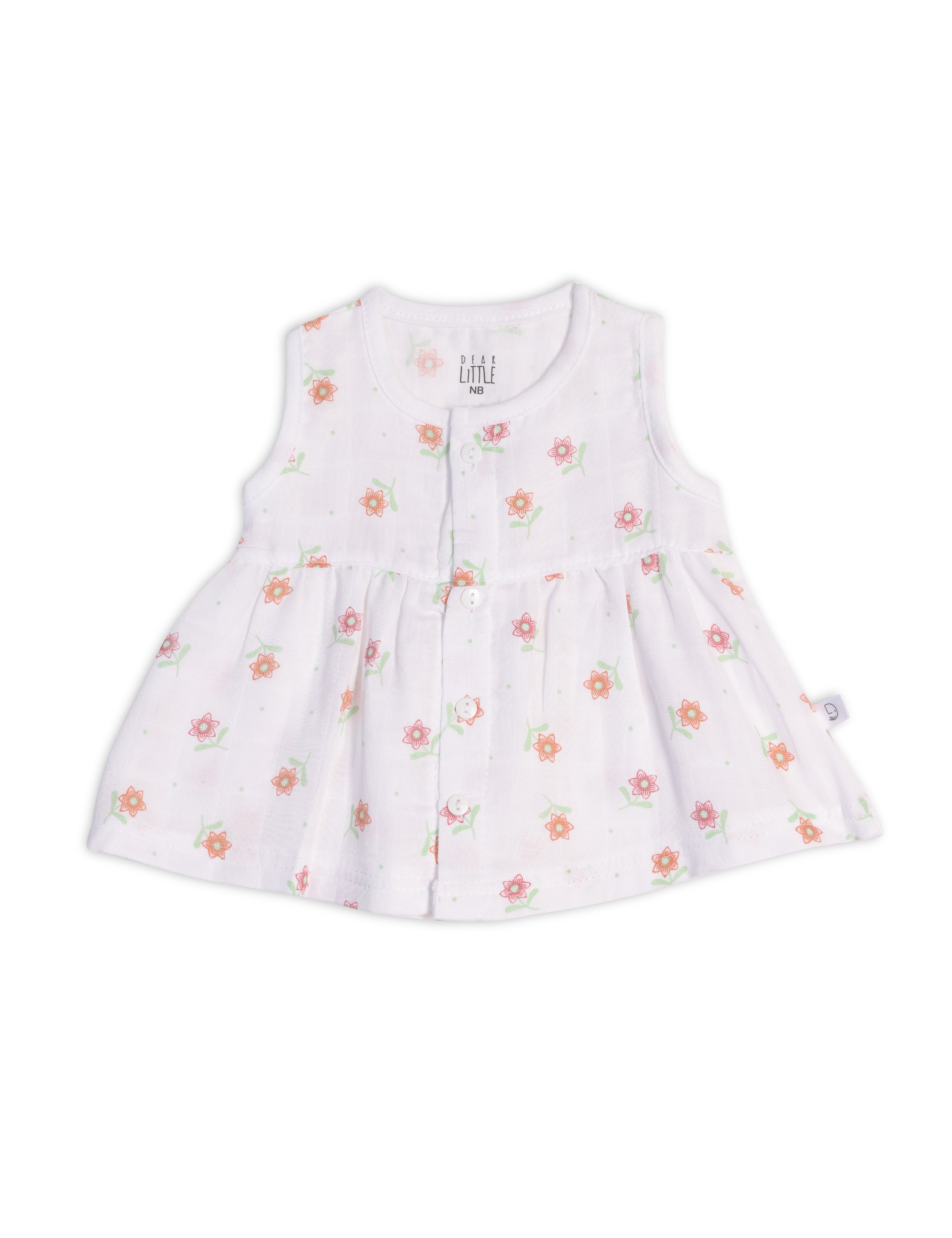 A sleeveless white baby frock with floral prints, made from muslin fabric.