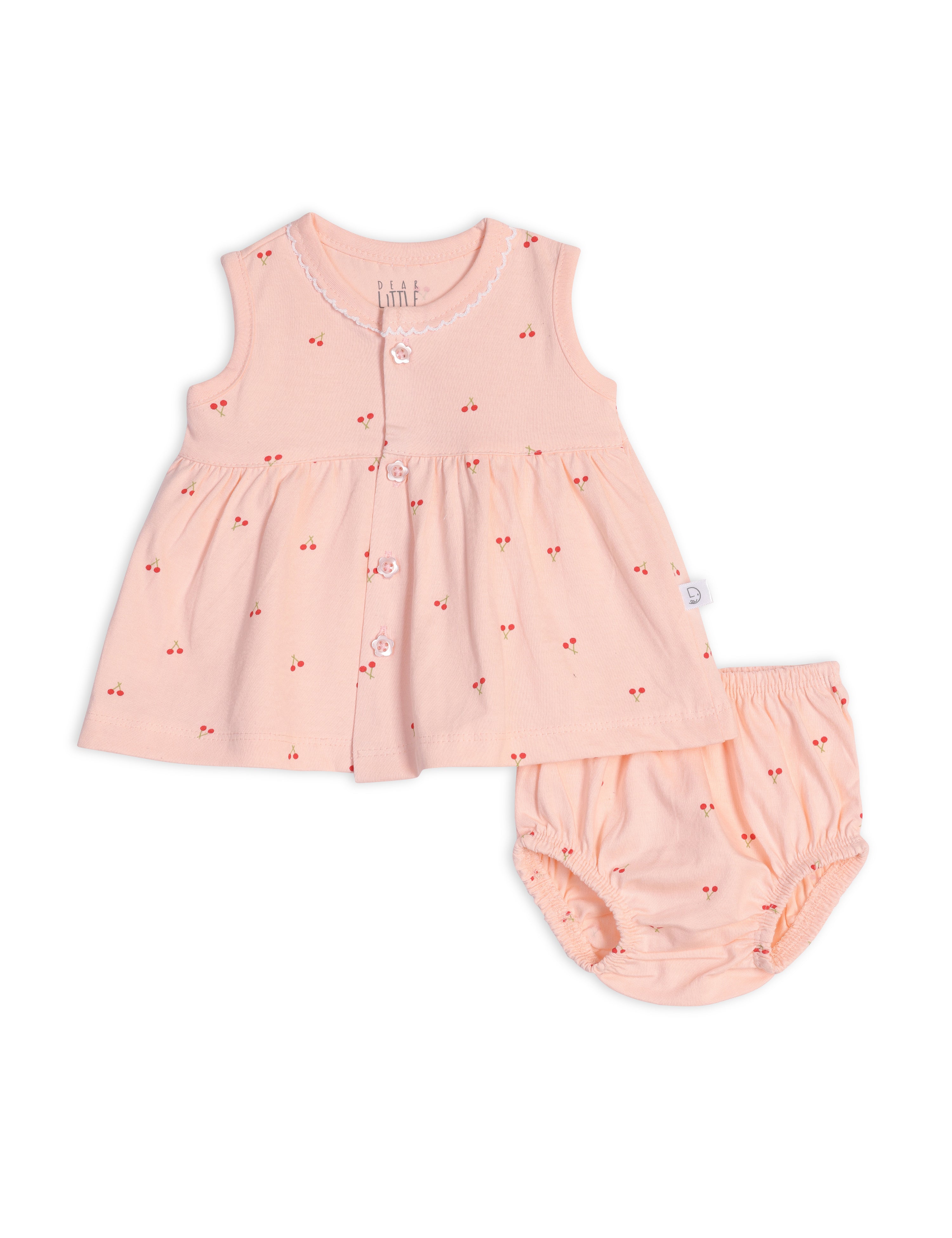 A sleeveless pink cotton frock with cherry blossom prints paired with a matching bloomer.