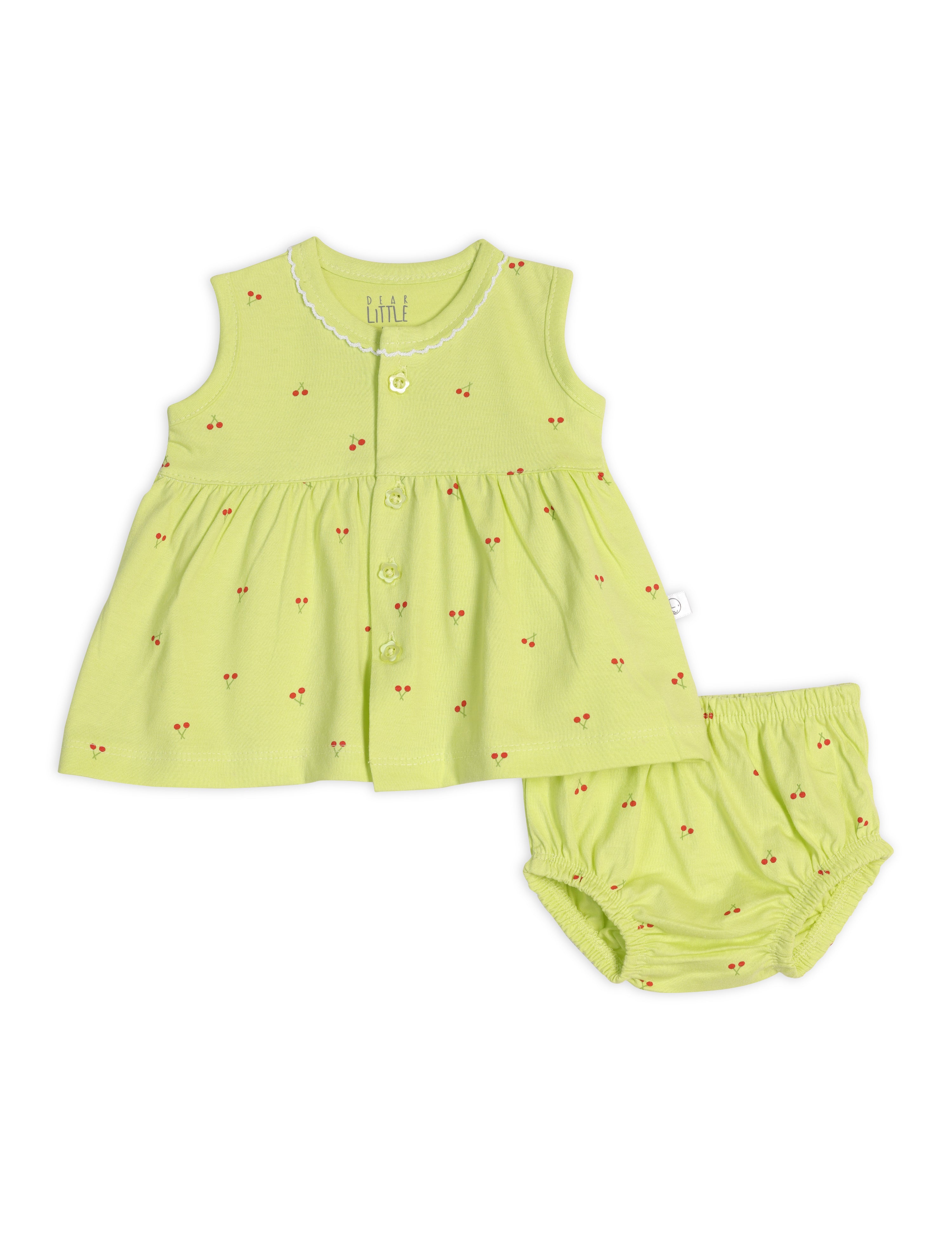 A sleeveless green cotton frock for babies with cherry blossom prints, accompanied by a matching bloomer.