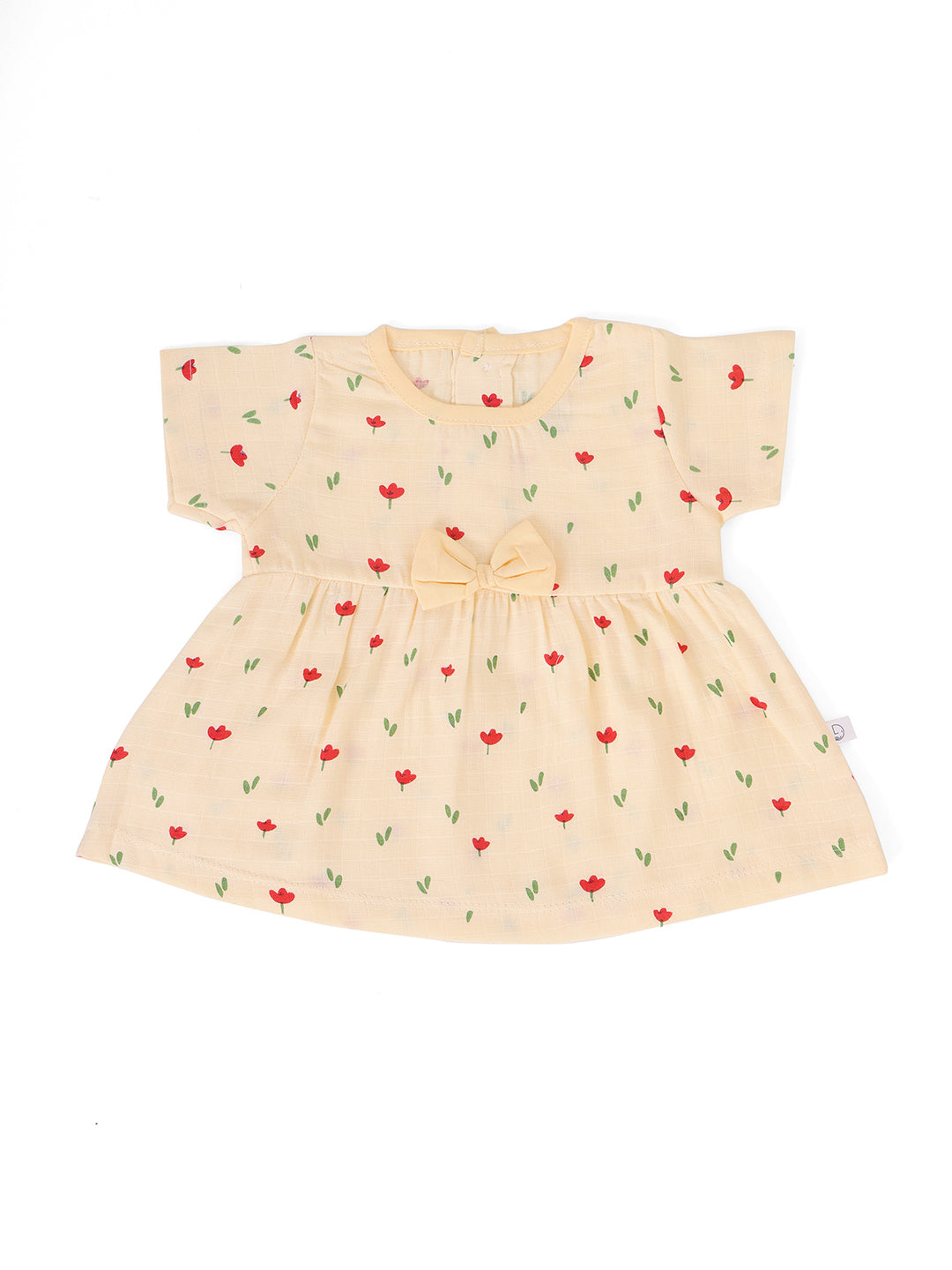 A beige half sleeve muslin bow frock with red floral print and green leaves, displayed against a white background.