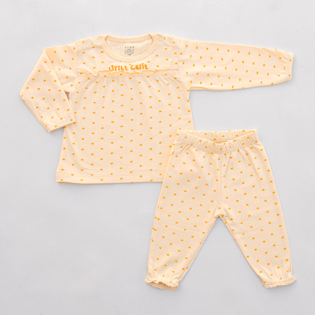 A set of children's clothing, with orange top and matching leggings, featuring heart patterns and lace trim.