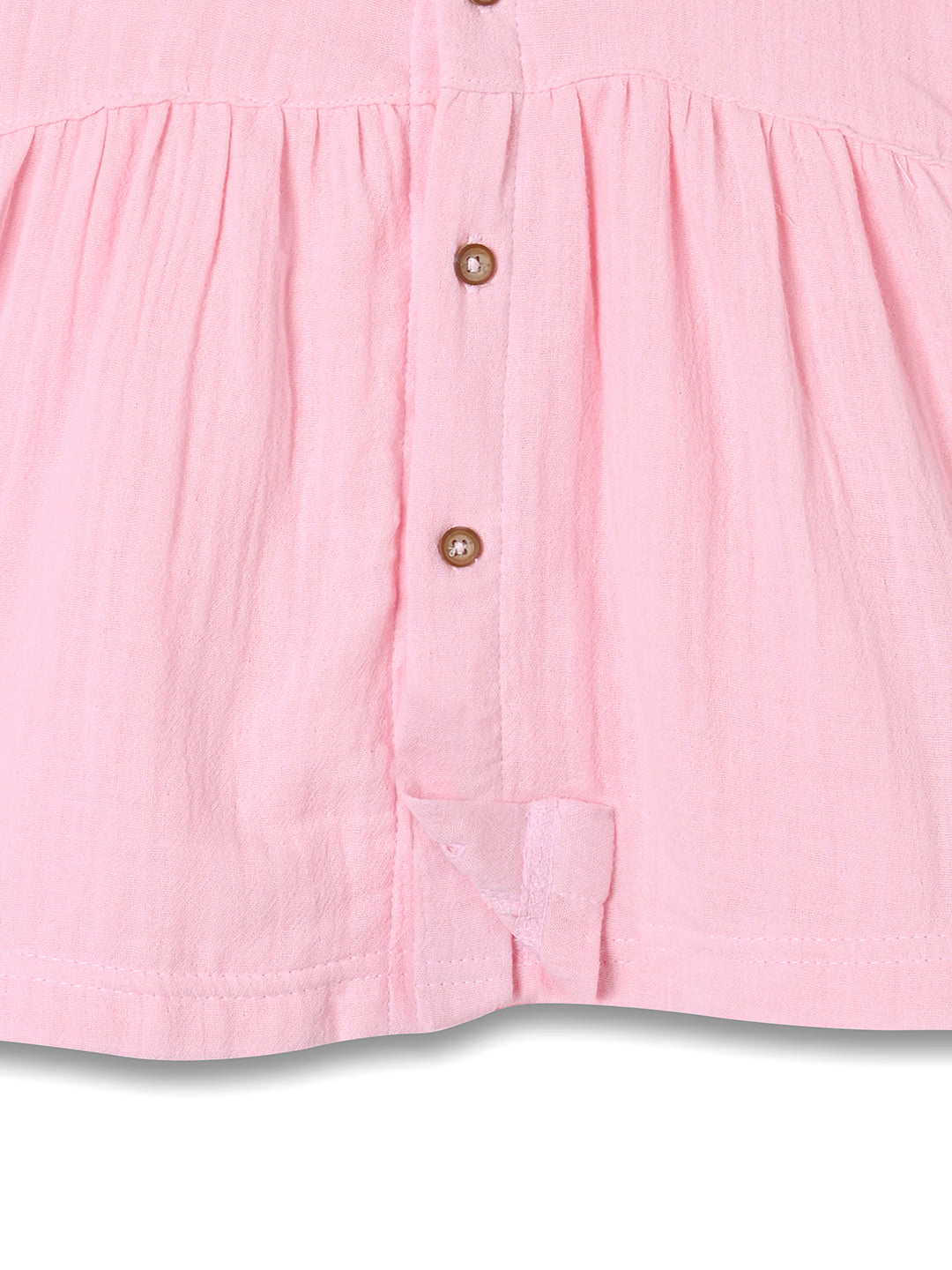 Close-up of a pink shirt with buttons