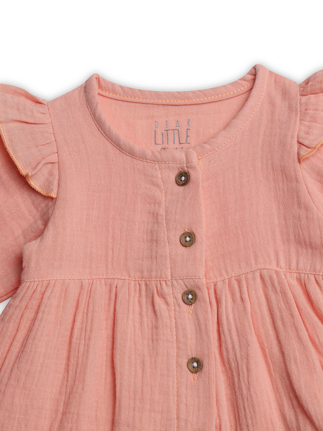 Pink dress with ruffled sleeves and buttons on a white background