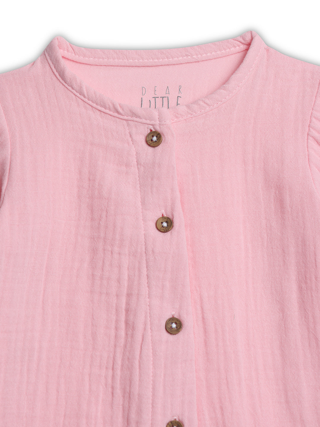 Close-up of a pink sleeveless top with button details on a white background