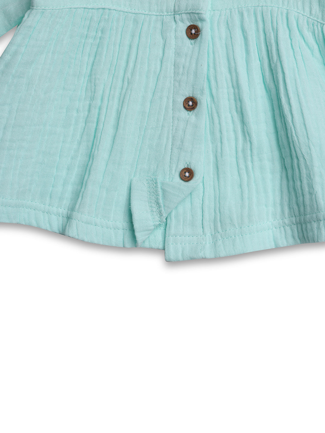 Close-up of a teal textured fabric with buttons 