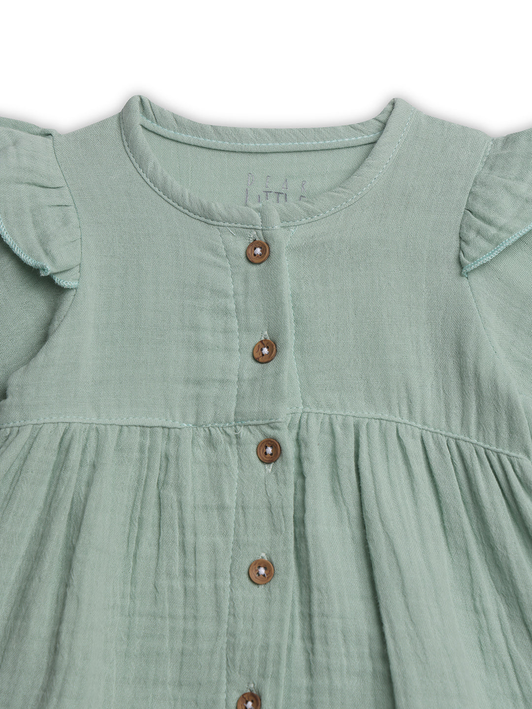 Green dress with buttons on a white background