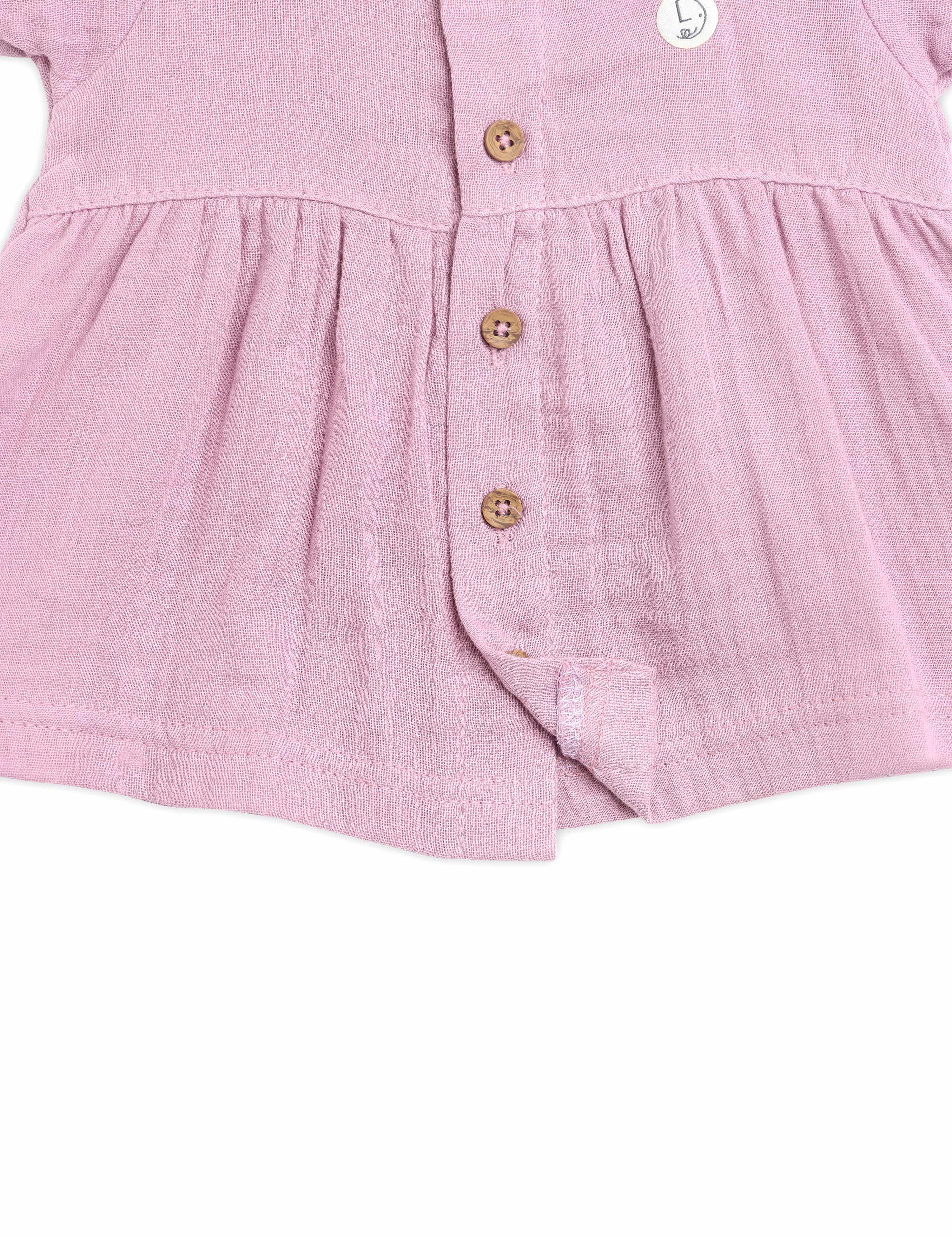 Pink dress with buttons on a white background