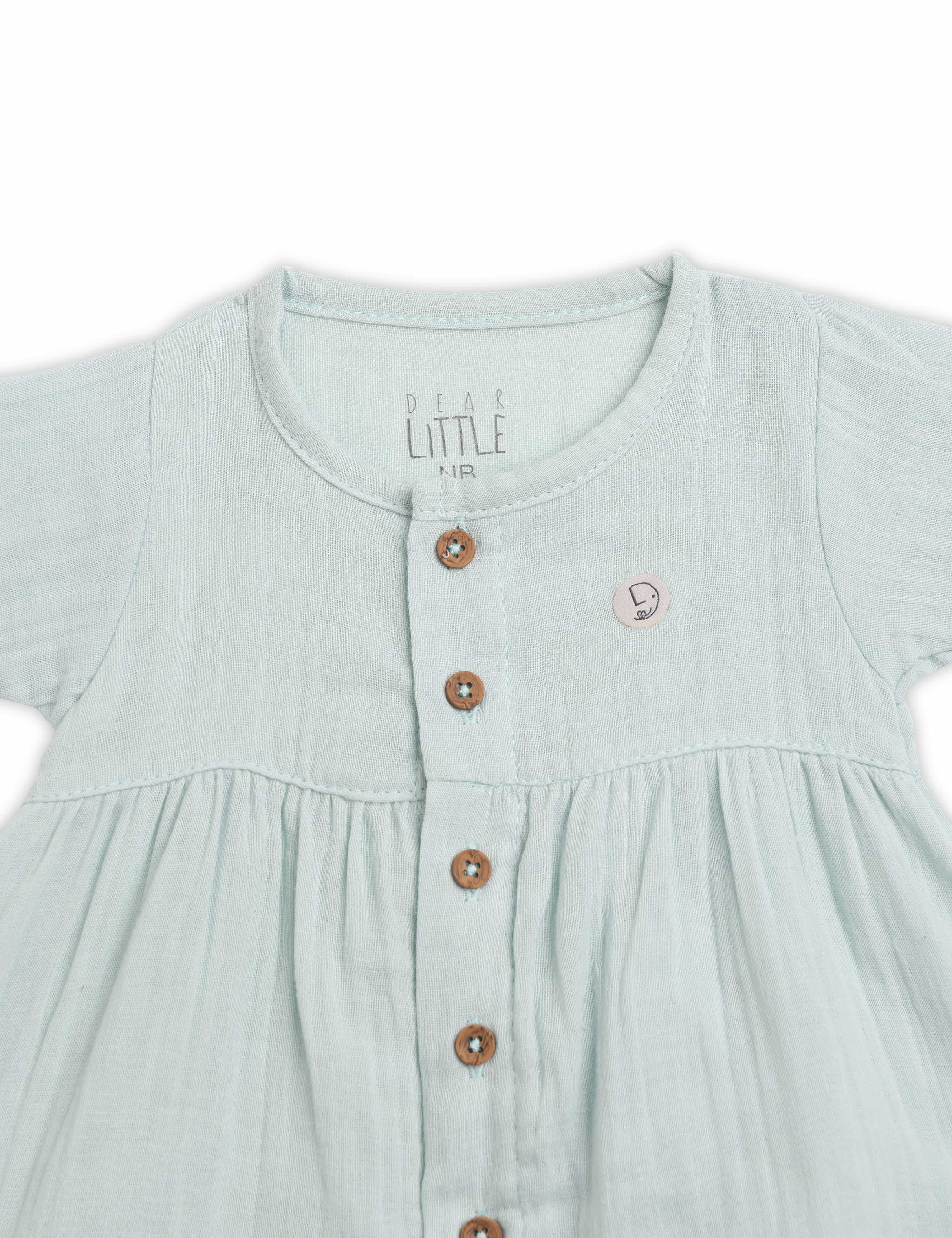 Light blue dress with buttons on a white background