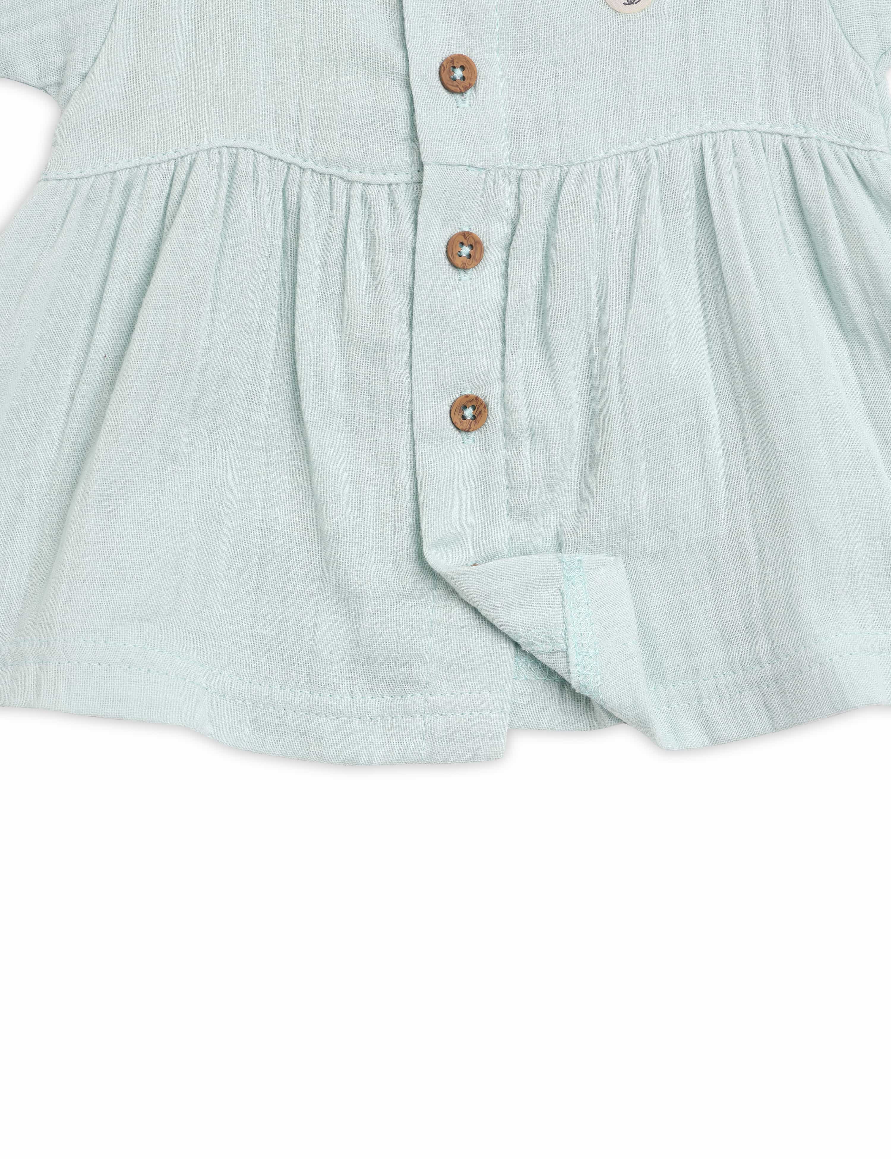 Light blue dress with buttons on a white background