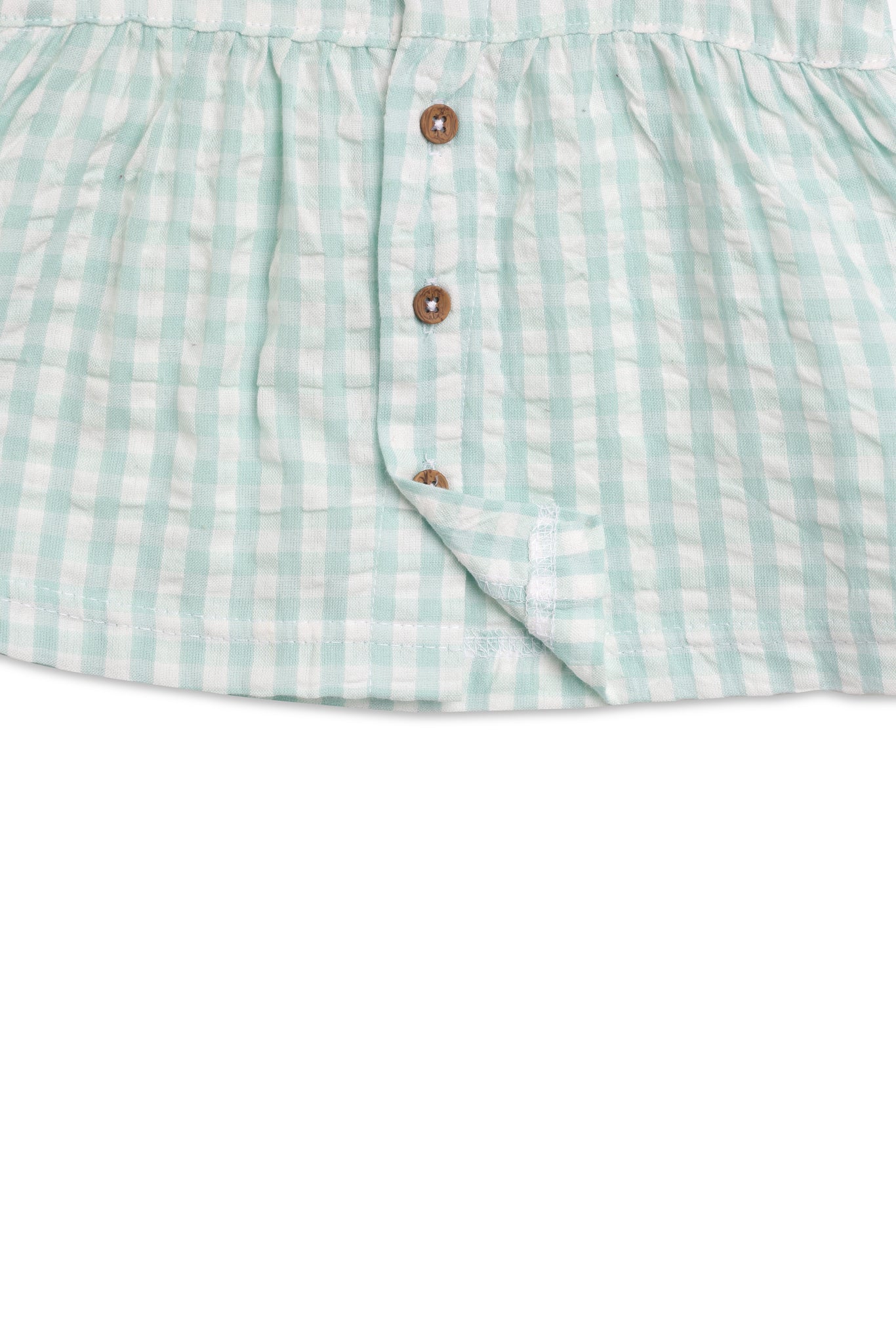 Green and white checkered skirt with button details on a white background