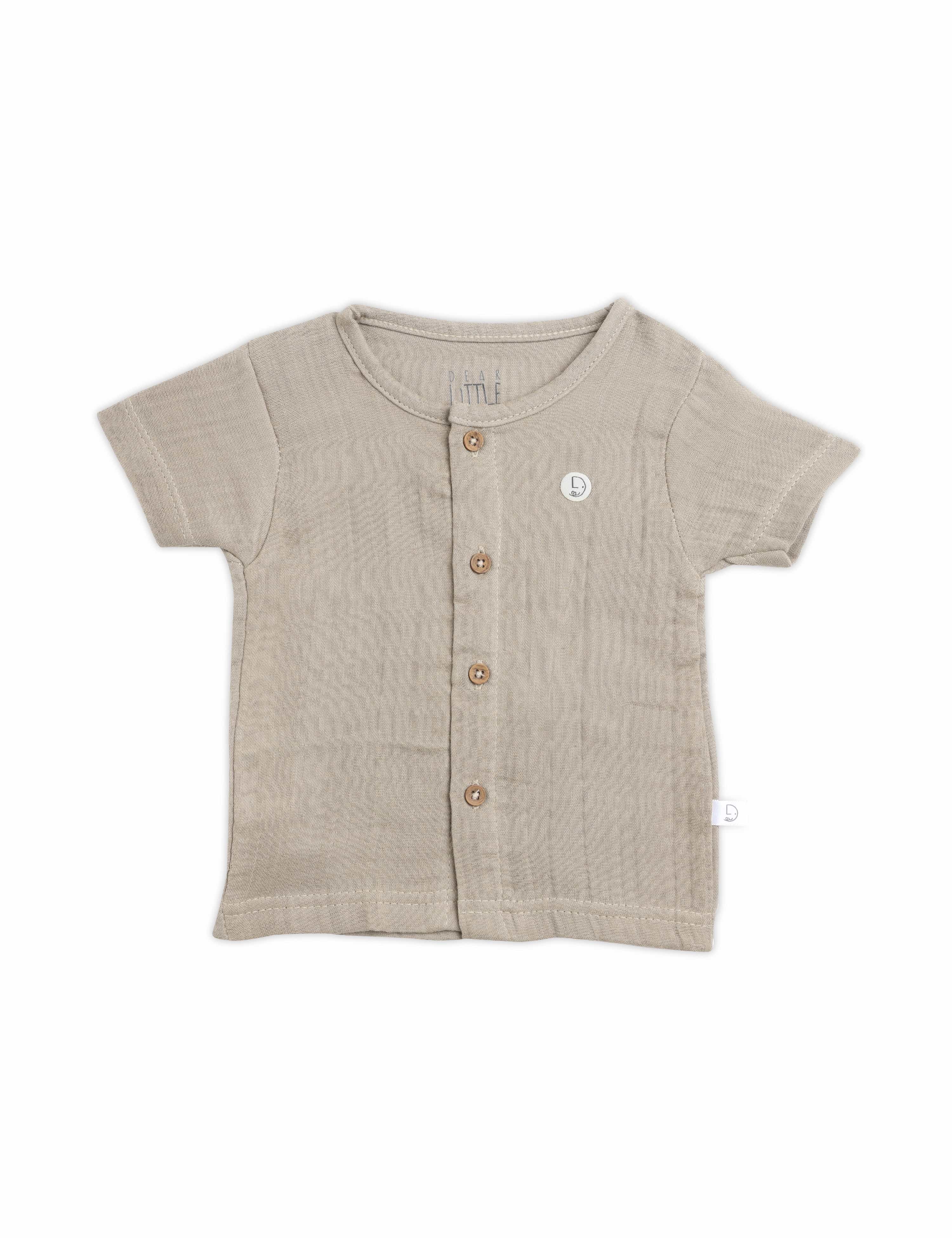 Beige baby shirt with buttons on a white background