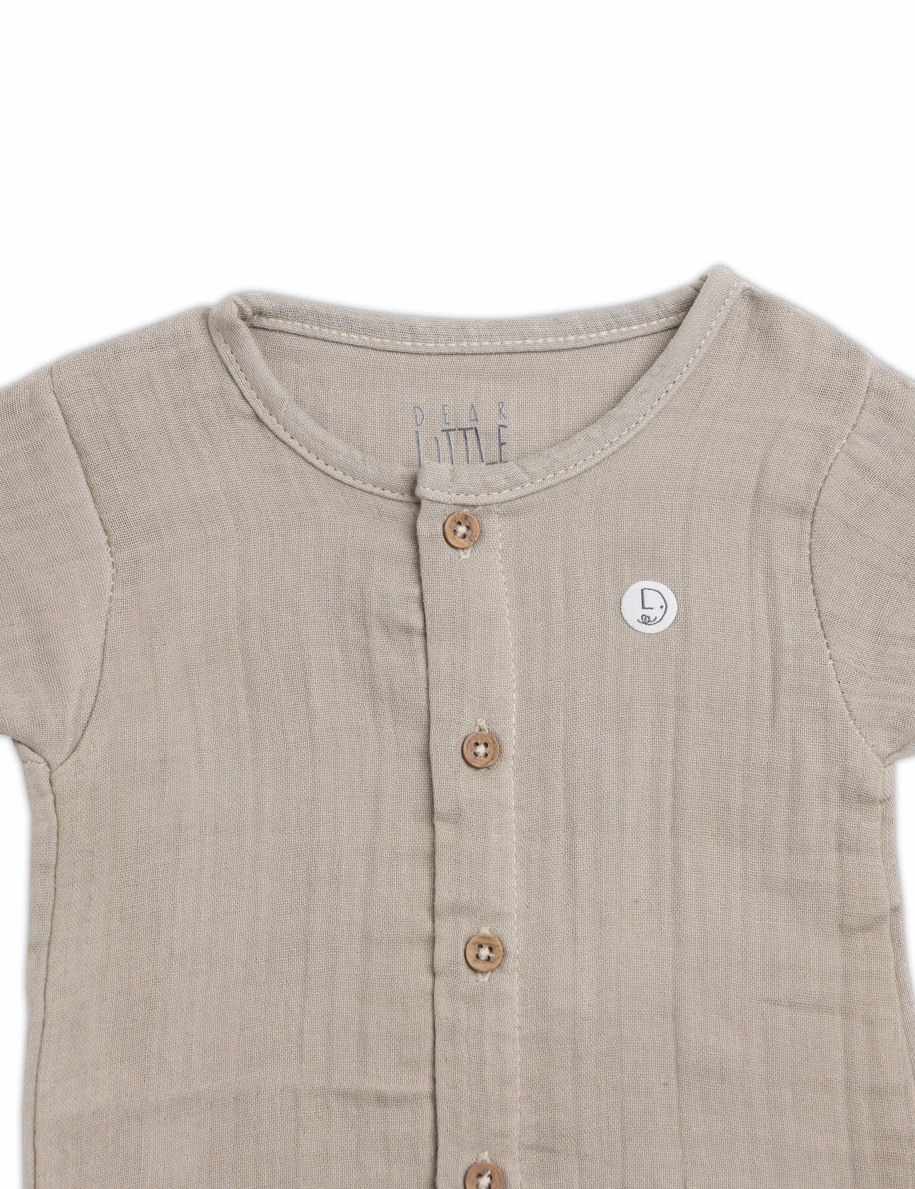 Beige baby romper with buttons on a white background