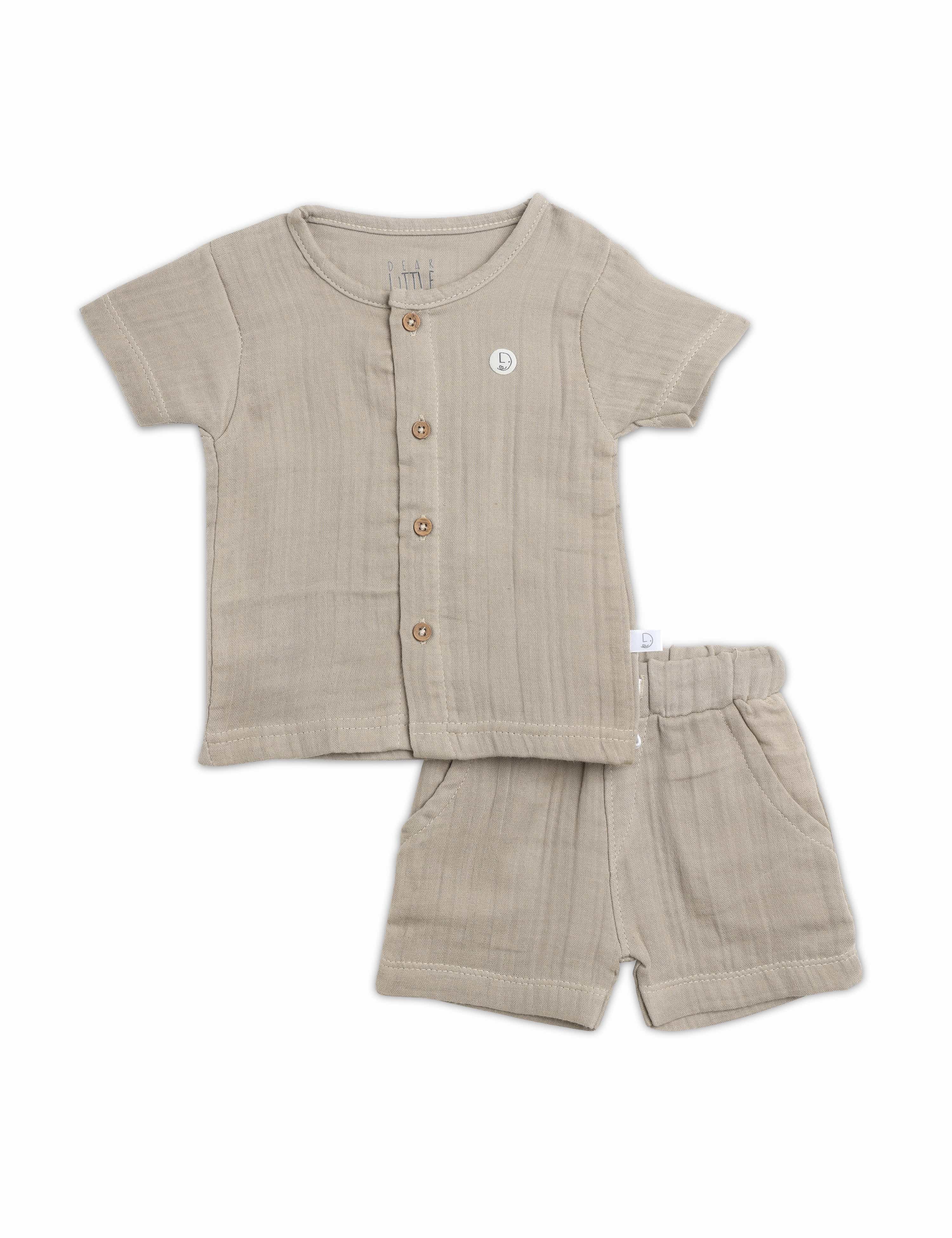 Beige baby shirt and shorts set on a white background