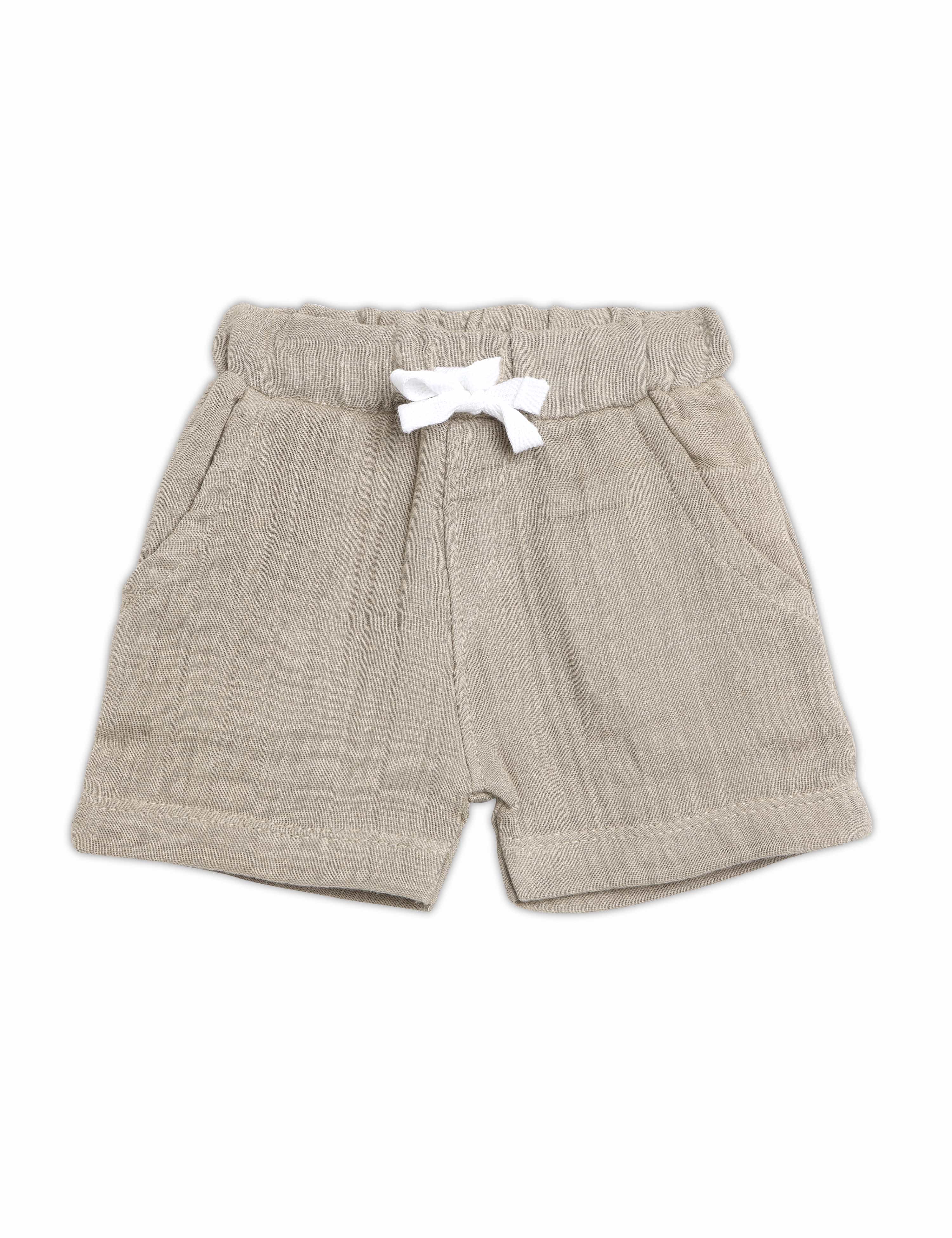 Beige shorts with a white bow on a white background