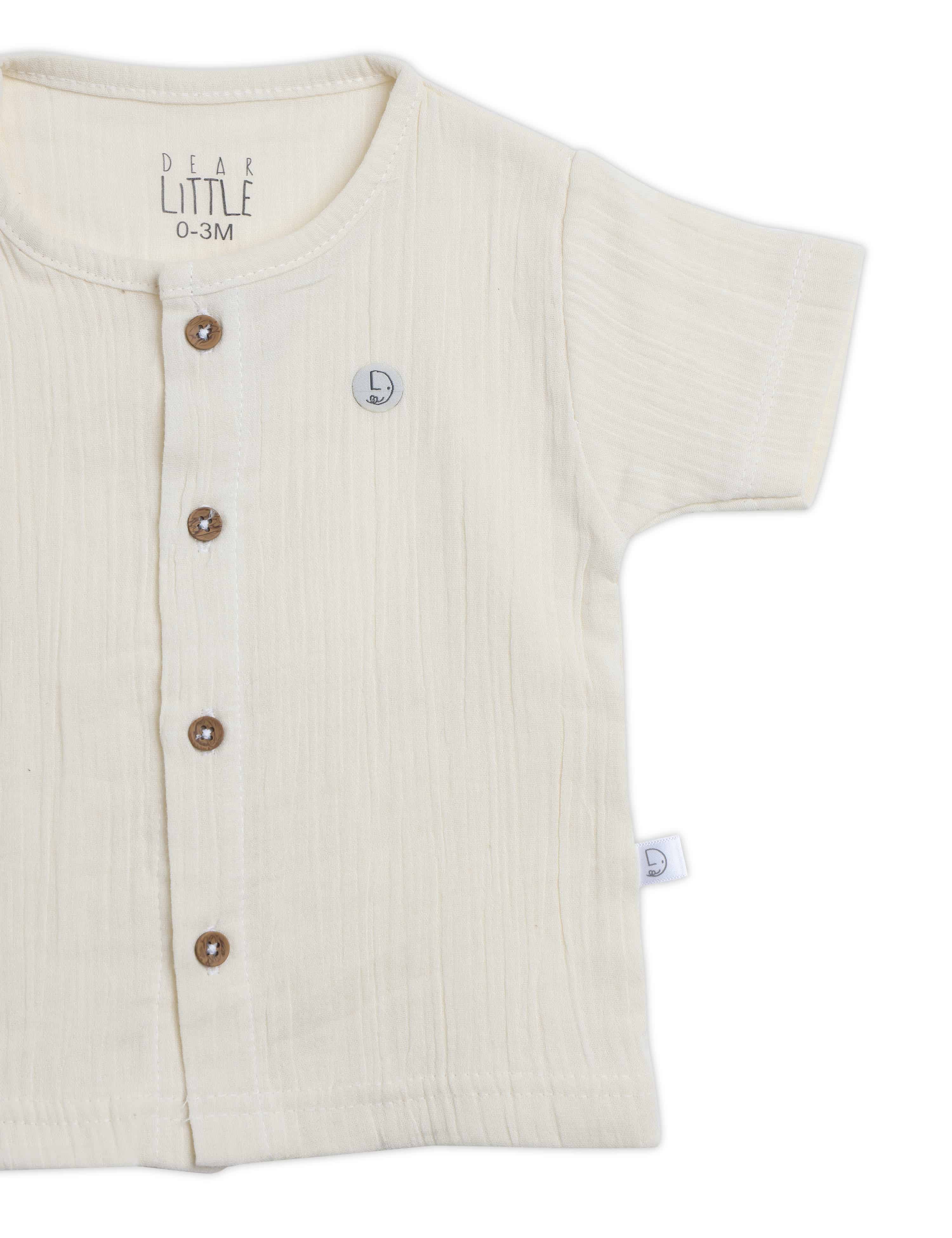 Beige baby shirt with buttons on a white background