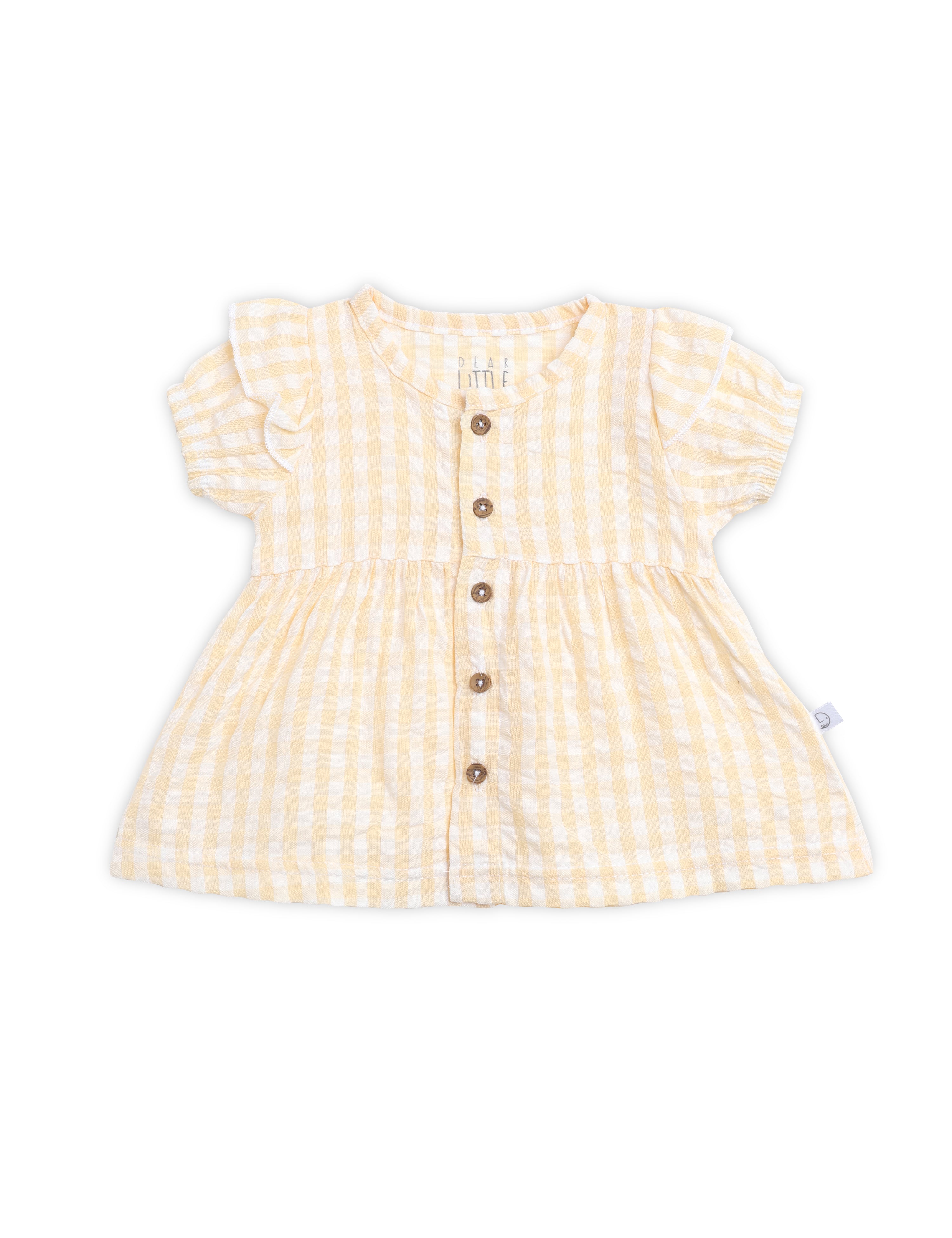 Yellow checkered dress with buttons on a white background