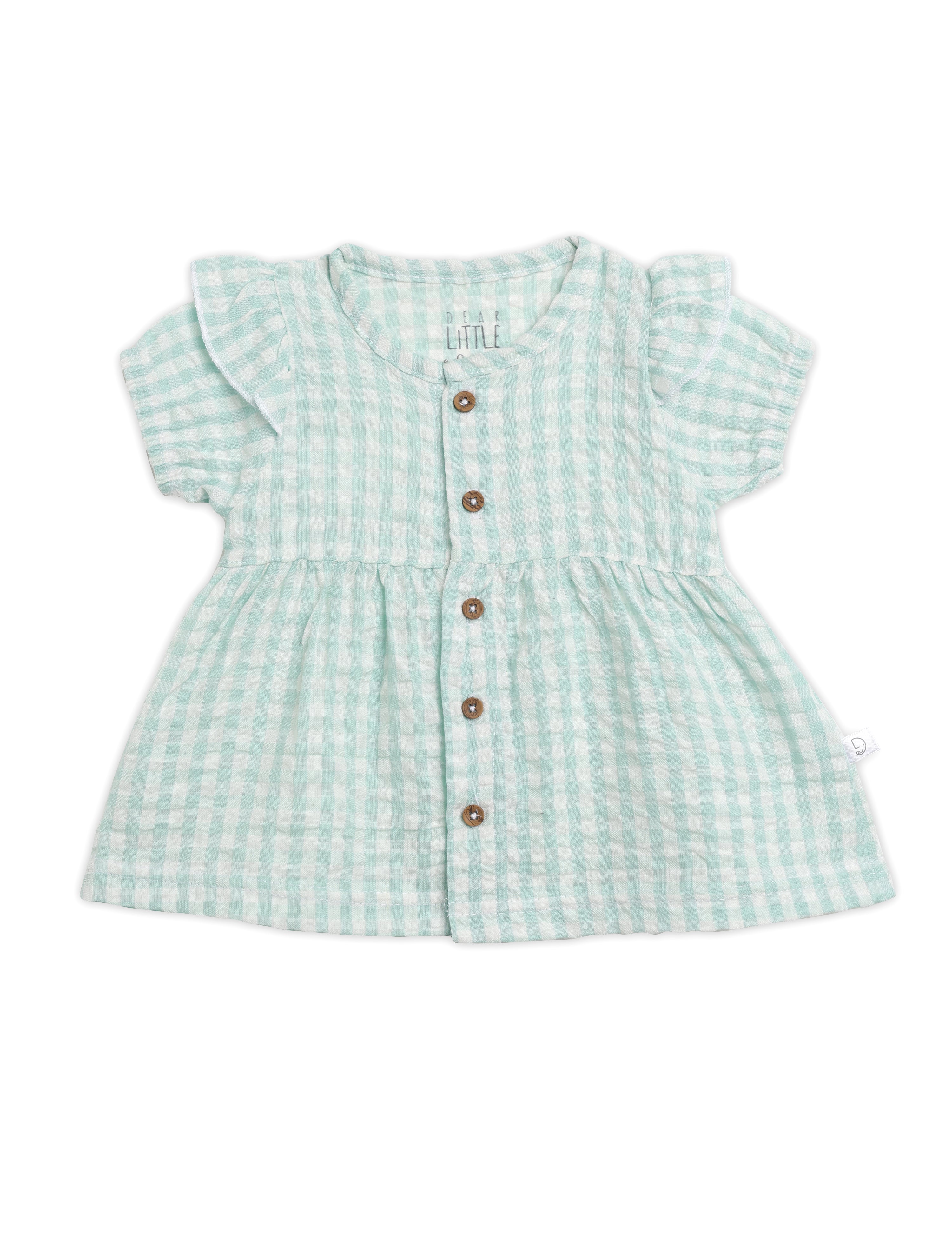 Green checkered dress with buttons on a white background