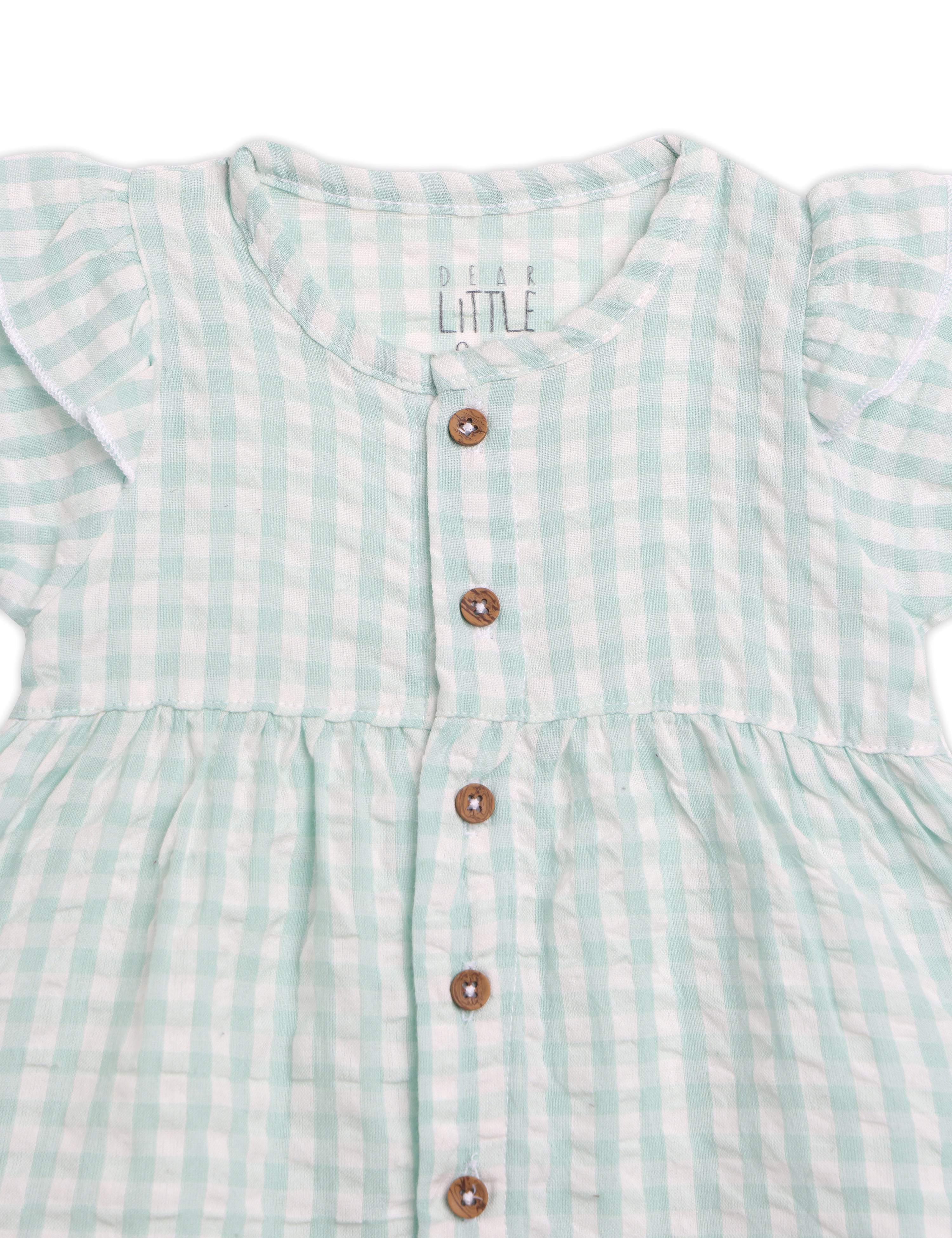 Green checkered dress with buttons on a white background