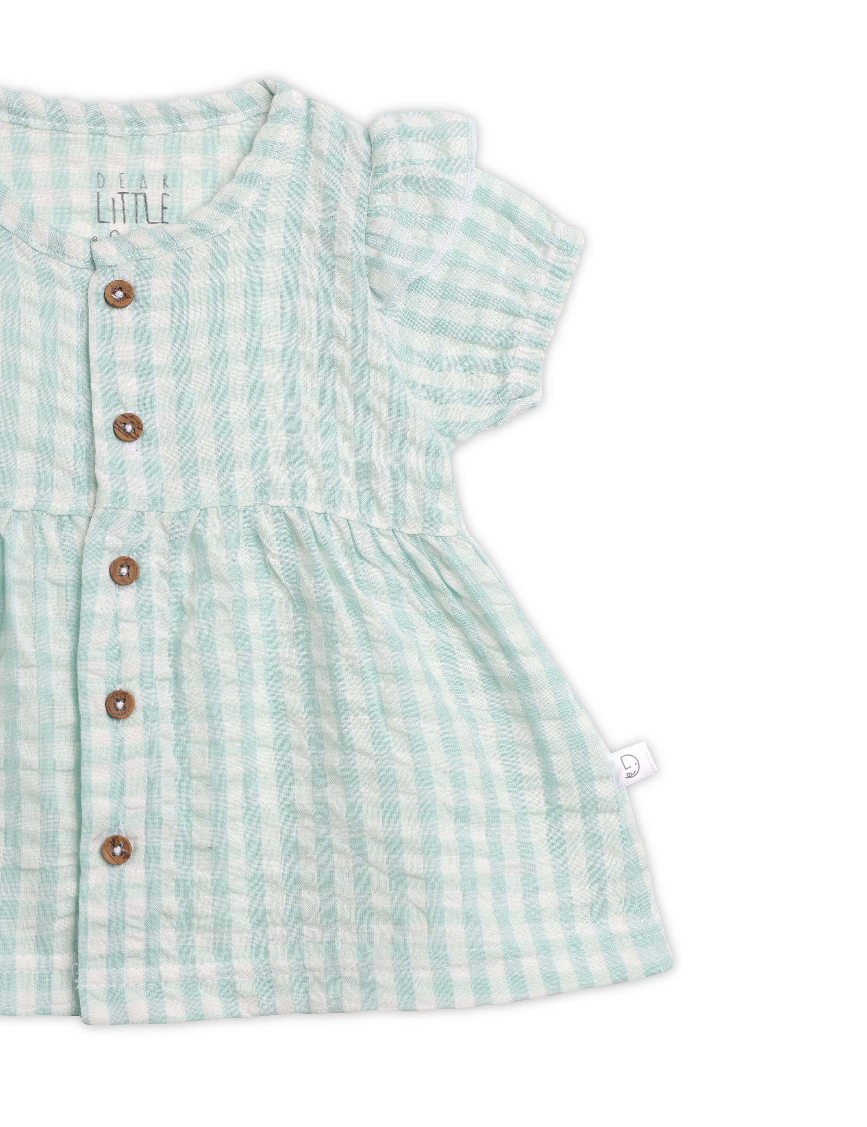 Green checkered dress with buttons on a white background
