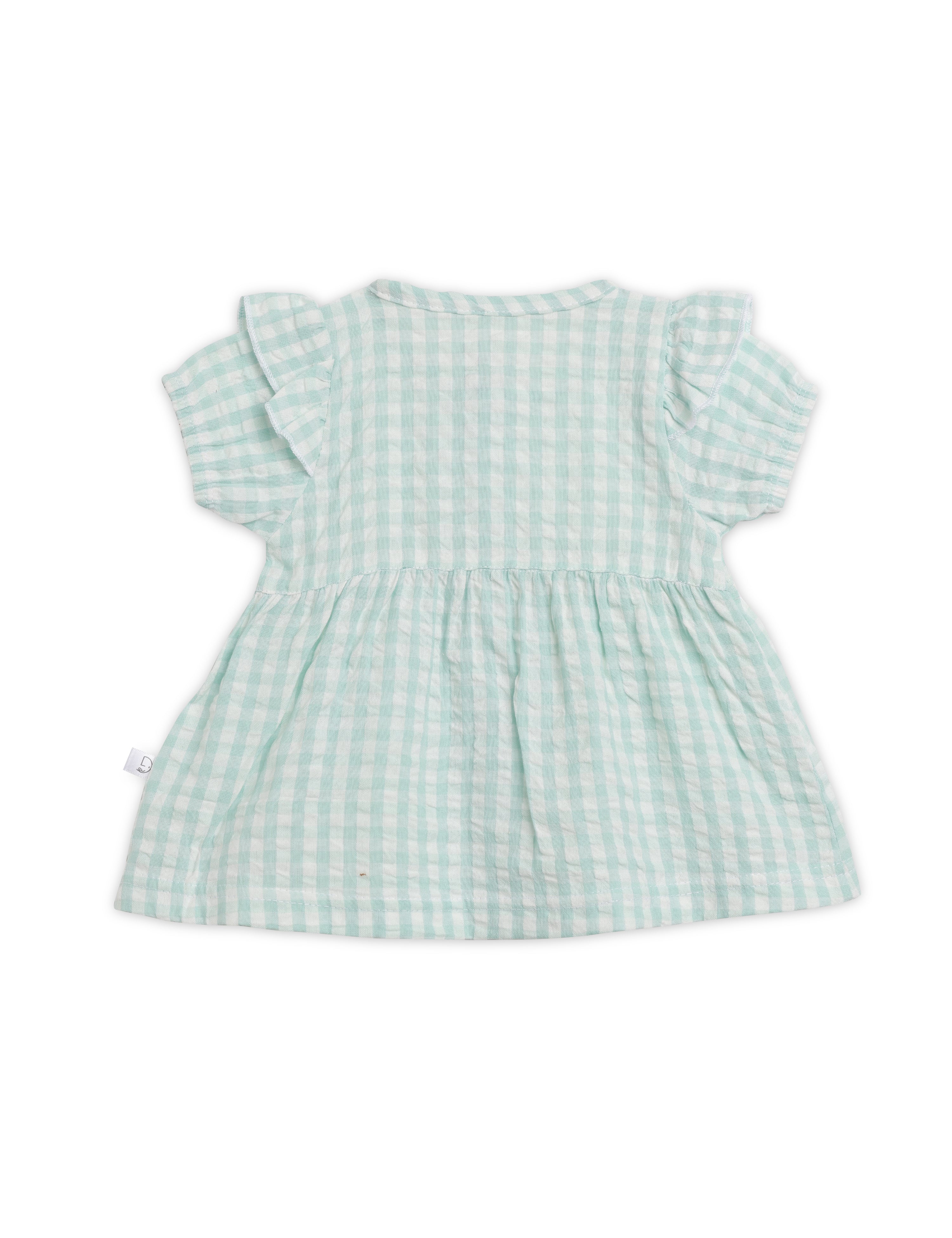 Green checkered dress on a white background
